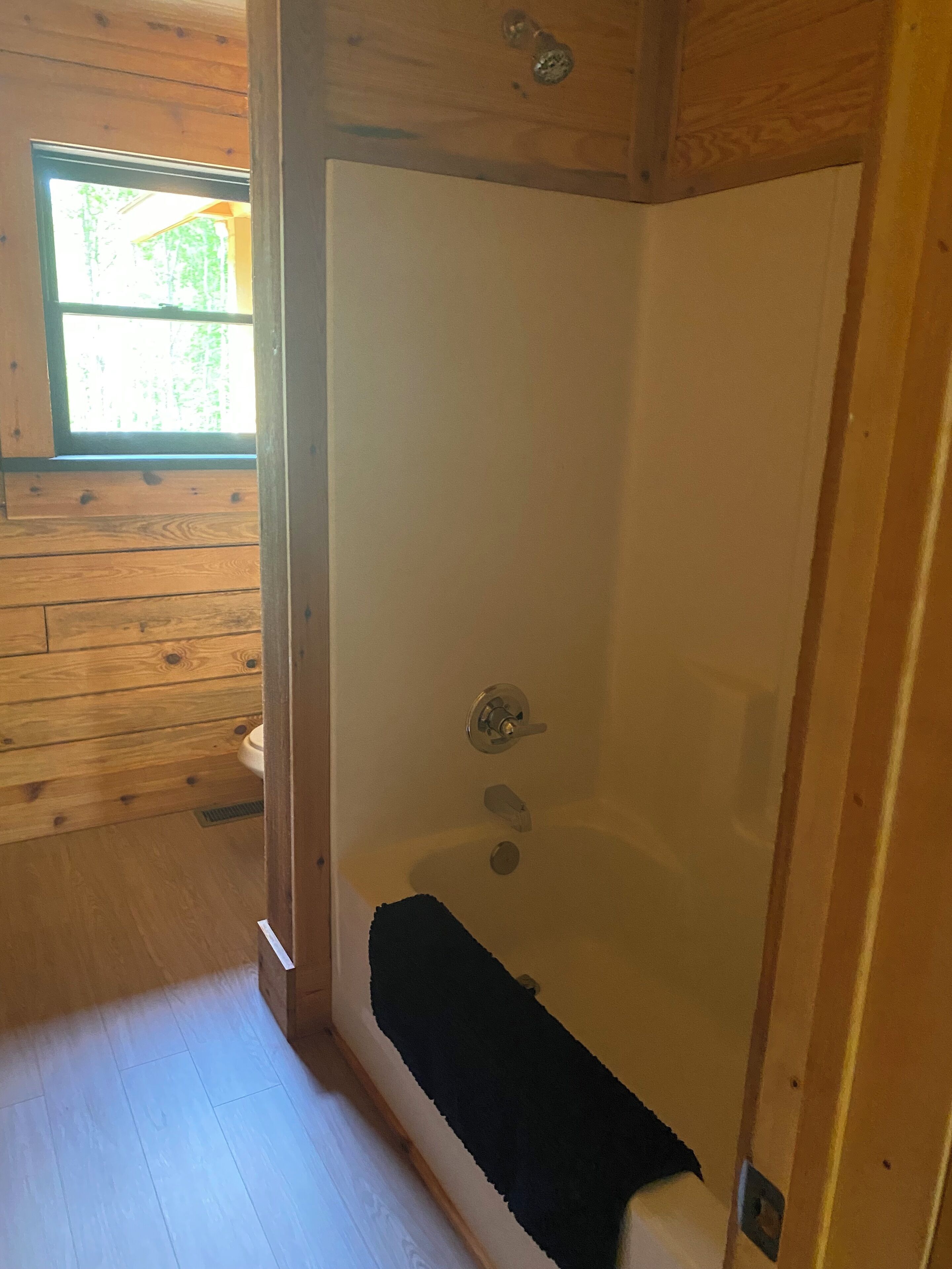 A wooden interior with a glass-enclosed shower area.