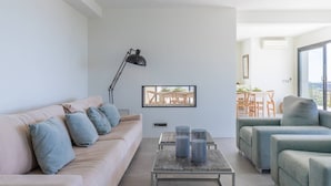 A modern living room with a sofa, armchairs, a coffee table, and a TV. - Villa met Zeezicht, Wifi en Airconditioning (Moraira)
