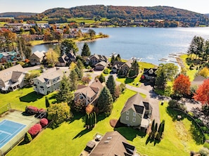 A residential area with houses, a tennis court, and a lake. - Ski Boots N' Bathing Suits by Taylor Made Deep Creek (McHenry)