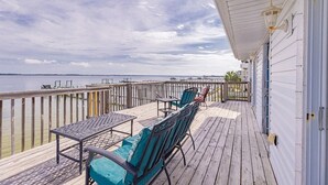 A wooden deck with outdoor furniture, a railing, and a view of the water. - Panferio Paradise, Water Front Home (Pensacola Beach)