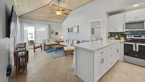 A modern kitchen with white cabinetry, a central island, and a built-in oven. - Golf Cart Included, Bimini Villa, Treasure Cay, Bahamas, 100 yards from beach (Treasure Cay)