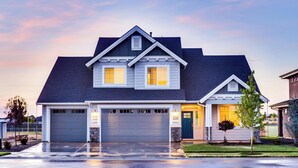 A two-story house with a garage, a well-maintained lawn, and a driveway. - German Property (Dresden)