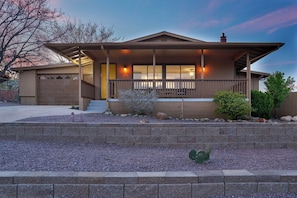 Enjoy a single-story home with a cozy front porch, garage, and beautifully maintained yard.