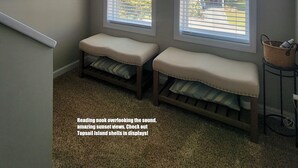 A reading nook with large windows, a bench, and framed artwork. - "Gay Dayz"4 bed/3.5bath w/pool/beach access (North Topsail Beach)