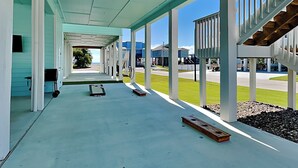 A covered outdoor area with a view of houses in the background. - Come And Catch It by Miss Kitty’s (Rockport)