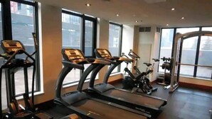 A gym with treadmills, stationary bikes, and weight machines.