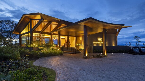 A modern hotel with a spacious entrance, a well-lit outdoor area, and a prominent sign. - Waldorf Astoria Costa Rica Punta Cacique (Sardinal)