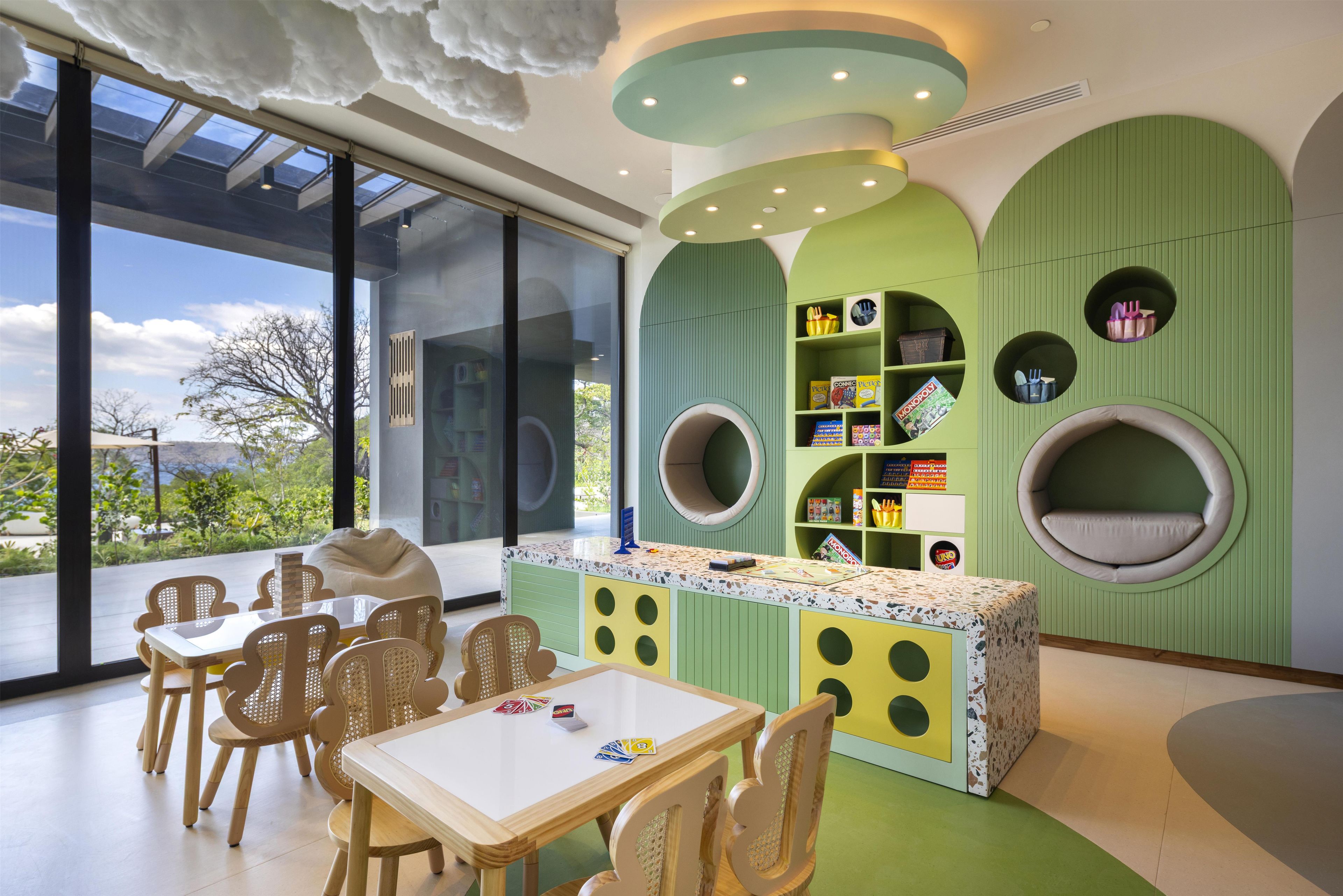 A children's play area with a table, chairs, and circular seating.