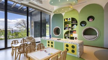 A children's play area with a table, chairs, and circular seating.