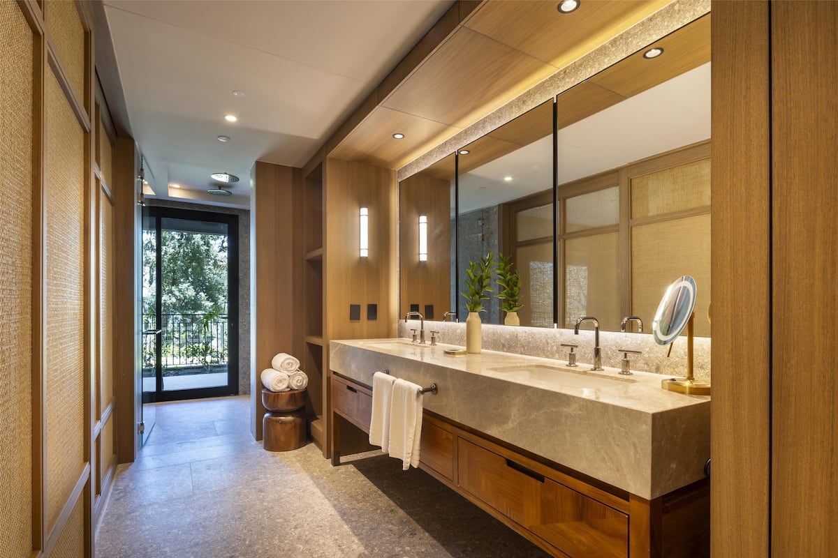 A modern bathroom with a large vanity, dual sinks, and a large mirror.