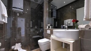 A modern bathroom with a glass-enclosed shower, a white toilet, and a vanity with a sink. - Via Porto Rooms - Deluxe Double Room with Double Bed and Balcony (Split)