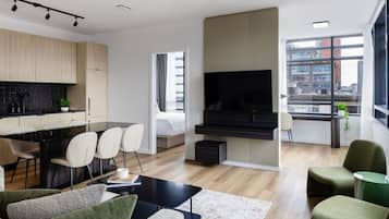 A modern living room with a dining area, a kitchen, and a large window with a city view.