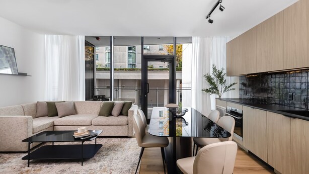 A modern apartment with a living room, dining area, and kitchen. - Smithe House (Vancouver)