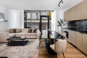 A modern apartment with a living room, dining area, and kitchen. - Smithe House (Vancouver)