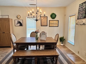 Enjoy meals with family and friends in this beautifully set dining area, featuring a wooden table and matching chairs.