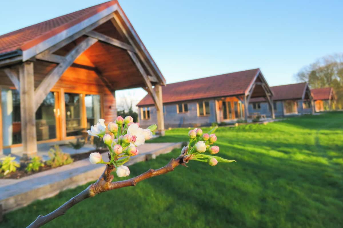 A wooden building with a sloped roof and a covered porch.