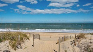 A beach with a wooden fence leading to the water, clear skies, and ocean waves. - OceanSound - 500 Feet to the Ocean in Duck, NC! (Kitty Hawk)
