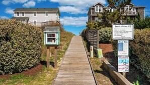 A wooden pathway leading to beach access with a signboard listing rules. - OceanSound - 500 Feet to the Ocean in Duck, NC! (Kitty Hawk)