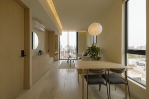 Deluxe Apartment, Balcony, City View | Dining room