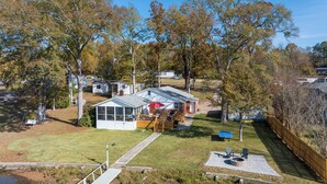 A residential property with a detached house, a covered patio, and a fenced yard. - Lakefront Getaway: Fire Pit ~ Dock ~ Games ~ Family & Pet Friendly (Waterloo)