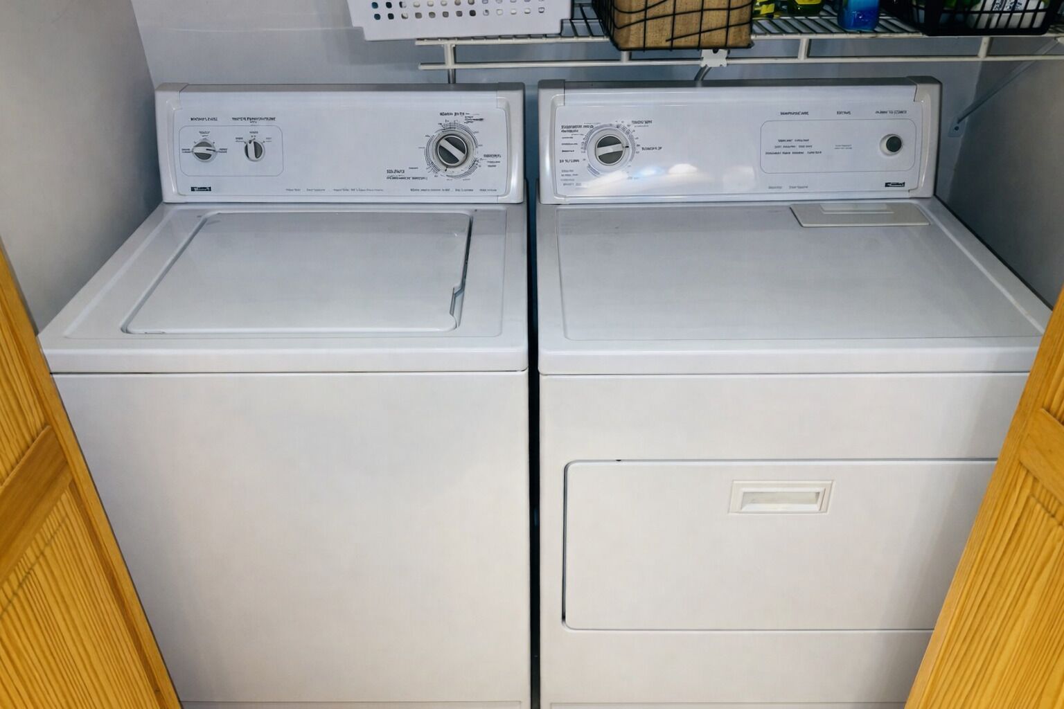 A laundry room with two stacked front-loading washing machines.