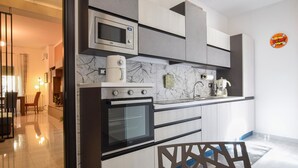 A modern kitchen with a built-in microwave, oven, and coffee maker. - 3 bedroom amazing apartment in Palermo (Palermo)