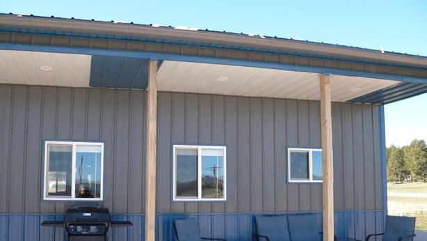 A covered outdoor seating area with a grill, two windows, and four chairs. - Country setting near Custer, Wi-Fi, AC, pet friendly w/fee. No cleaning fee. (Custer)