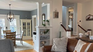 A spacious living room with a brown leather sofa, a grey armchair, and a round wooden coffee table with a candle. - Charming Pet-Friendly Stay: Walk BC, 7.5 mi to JMU, walk to Dining, Parks & more (Bridgewater)