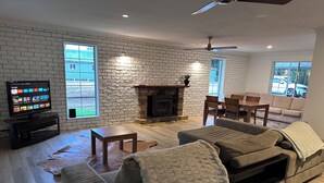 A living room with a fireplace, a television, and a sofa.