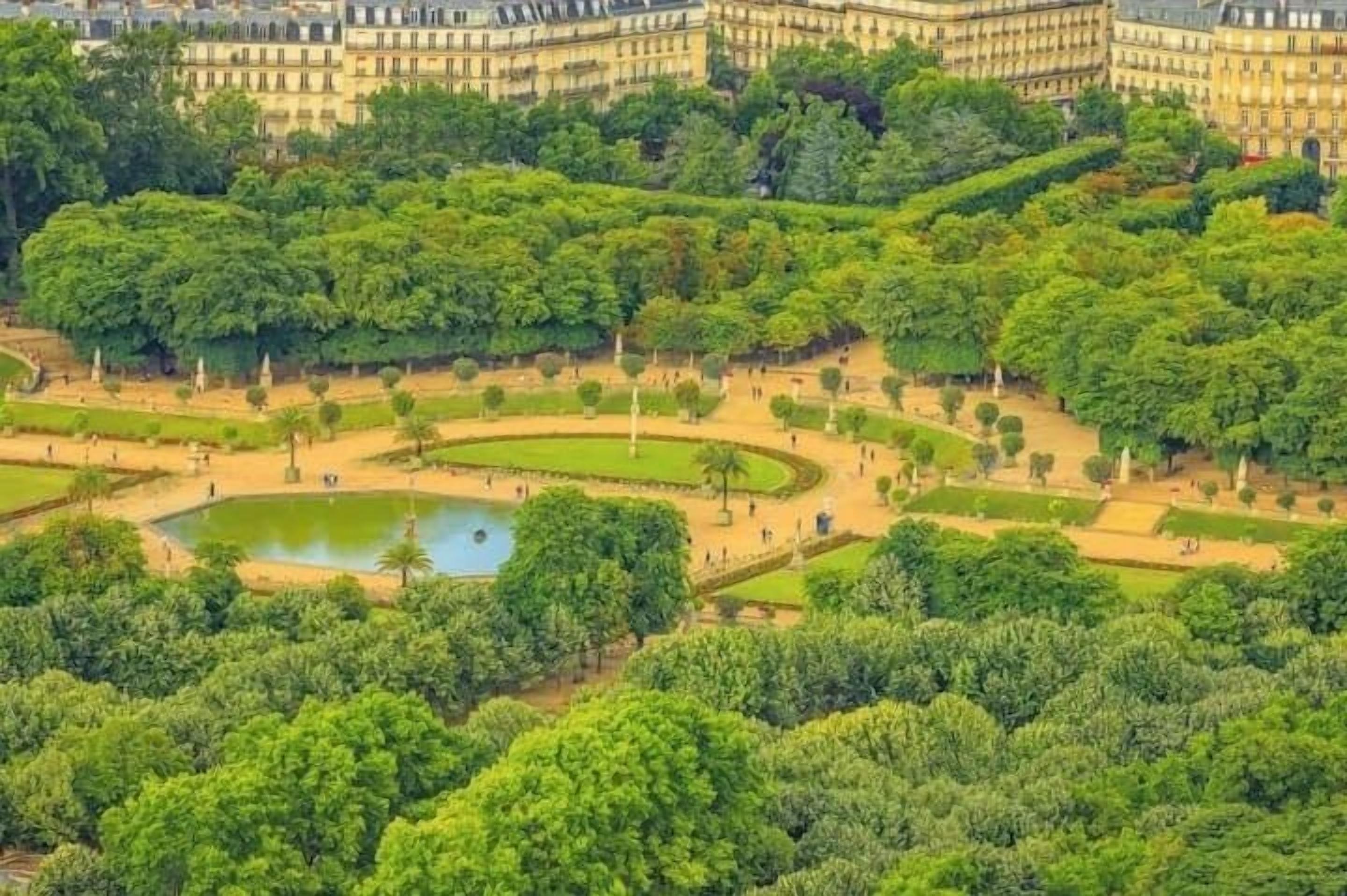 A large, historic building with a formal garden and a central pond.