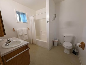 Un baño con lavamanos, inodoro y bañera.
