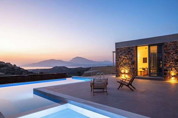 Relax by the pool with a view of the distant mountains.