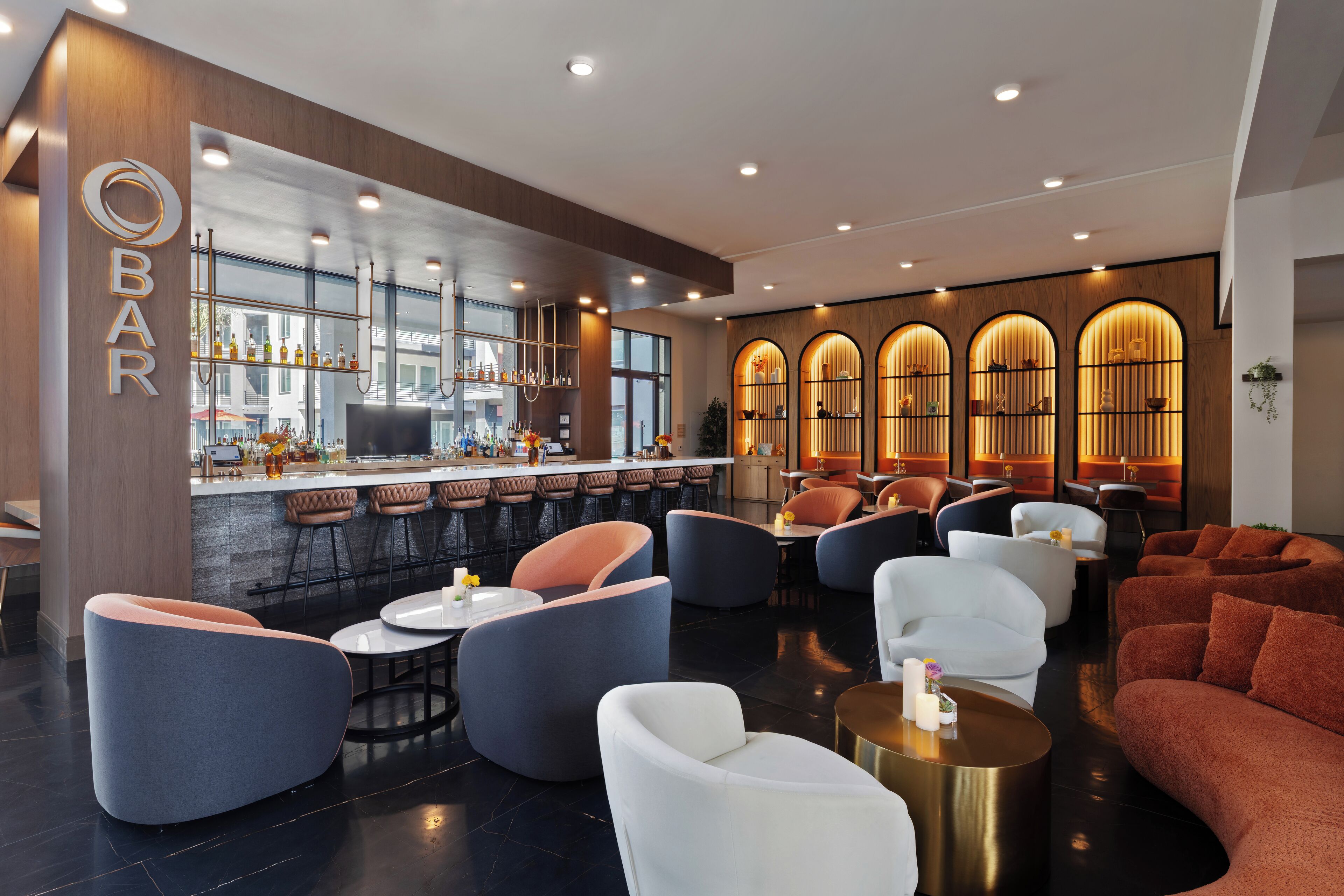 A modern bar area with seating and a bar counter.