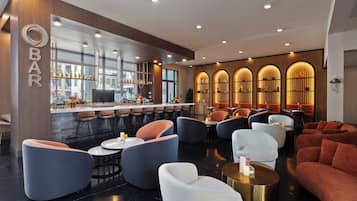 A modern bar area with seating and a bar counter.