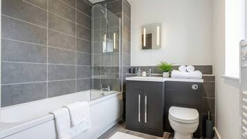 Shower, hair dryer, towels, shampoo