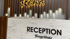 A reception desk with a marble top and a sign that reads "RECEPTION Hosgeldiniz". - Rena Grand Residence & Suite (Yomra)
