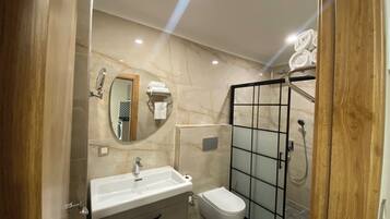 Deluxe Suite, Balcony | Bathroom | Shower, rainfall showerhead, hair dryer, bathrobes