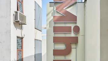 A building with a sign reading "Mihn Suites" indicating a hotel or lodging establishment.