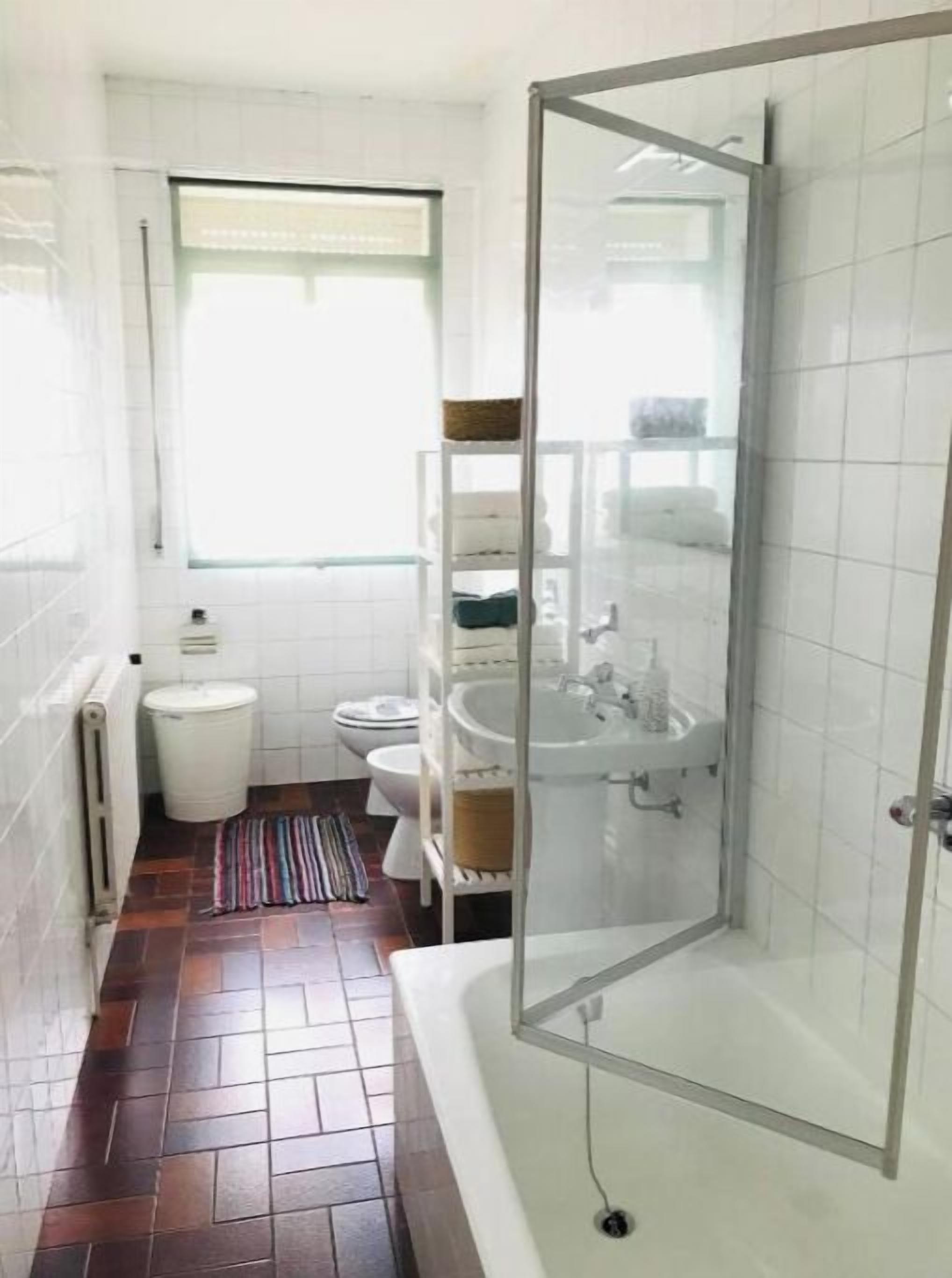 Un baño con ducha, inodoro y lavamanos.