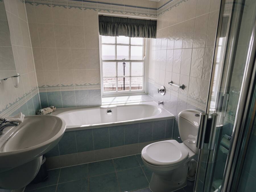 A bathroom with a bathtub, a toilet, and a sink.