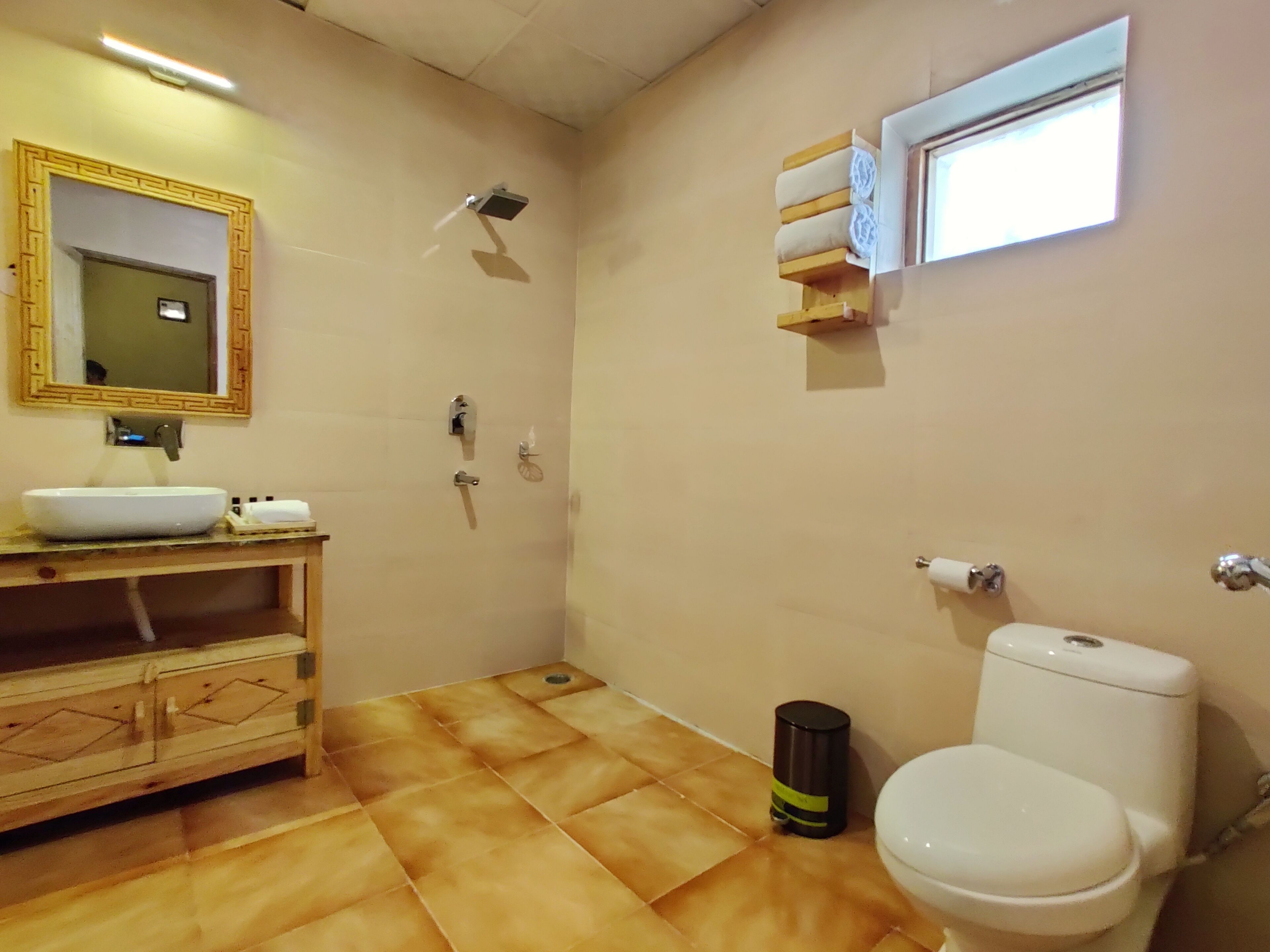 A bathroom with a sink, toilet, and mirror.
