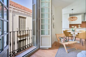 Een moderne keuken met een eethoek, een balkon met een balustrade en een schuifpui.