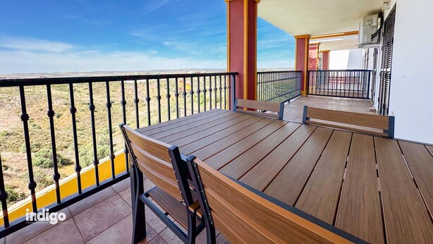 A wooden deck with a table and benches, overlooking a desert landscape. - Pleasant apartment with great views JUL01 (Ayamonte)