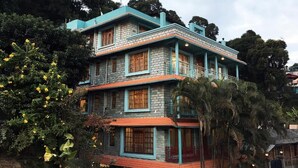 A multi-story building with a brick facade and blue trim. - Misson Valley Kalimpong (Kalimpong)