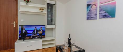 Classic Apartment, Courtyard View | Living area | 100-cm flat-screen TV with cable channels