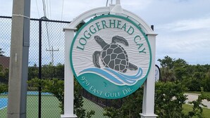 A sign for Loggerhead Cay with a turtle graphic, surrounded by greenery and a stone wall. - LOGGERHEAD CAY 501🌴Direct Gulf Front🏖️Sanibel Escape🏝️
Queen & Twin in spare room (Sanibel)