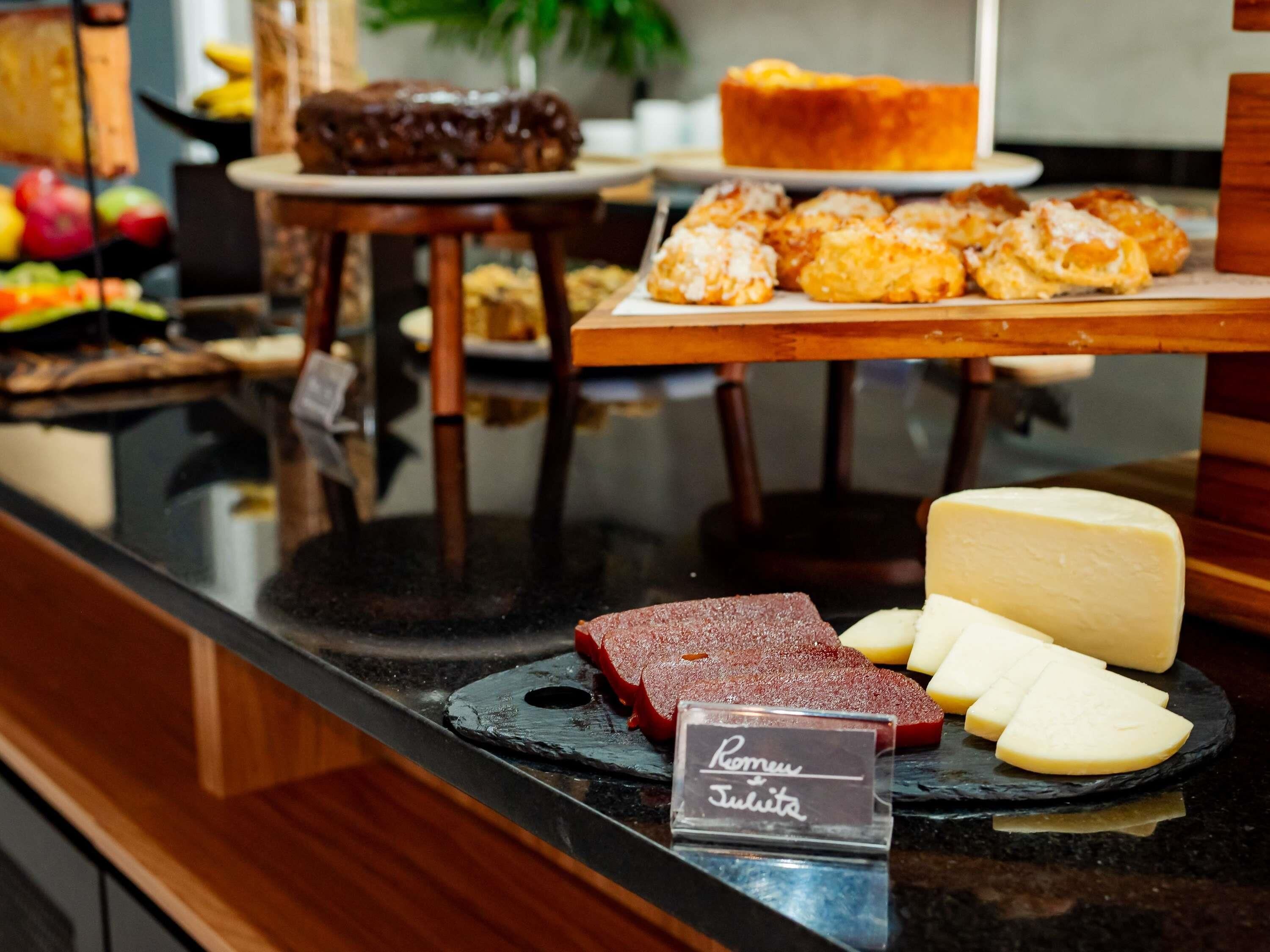 A cheese and meat display with a sign reading "Romus Julita".
