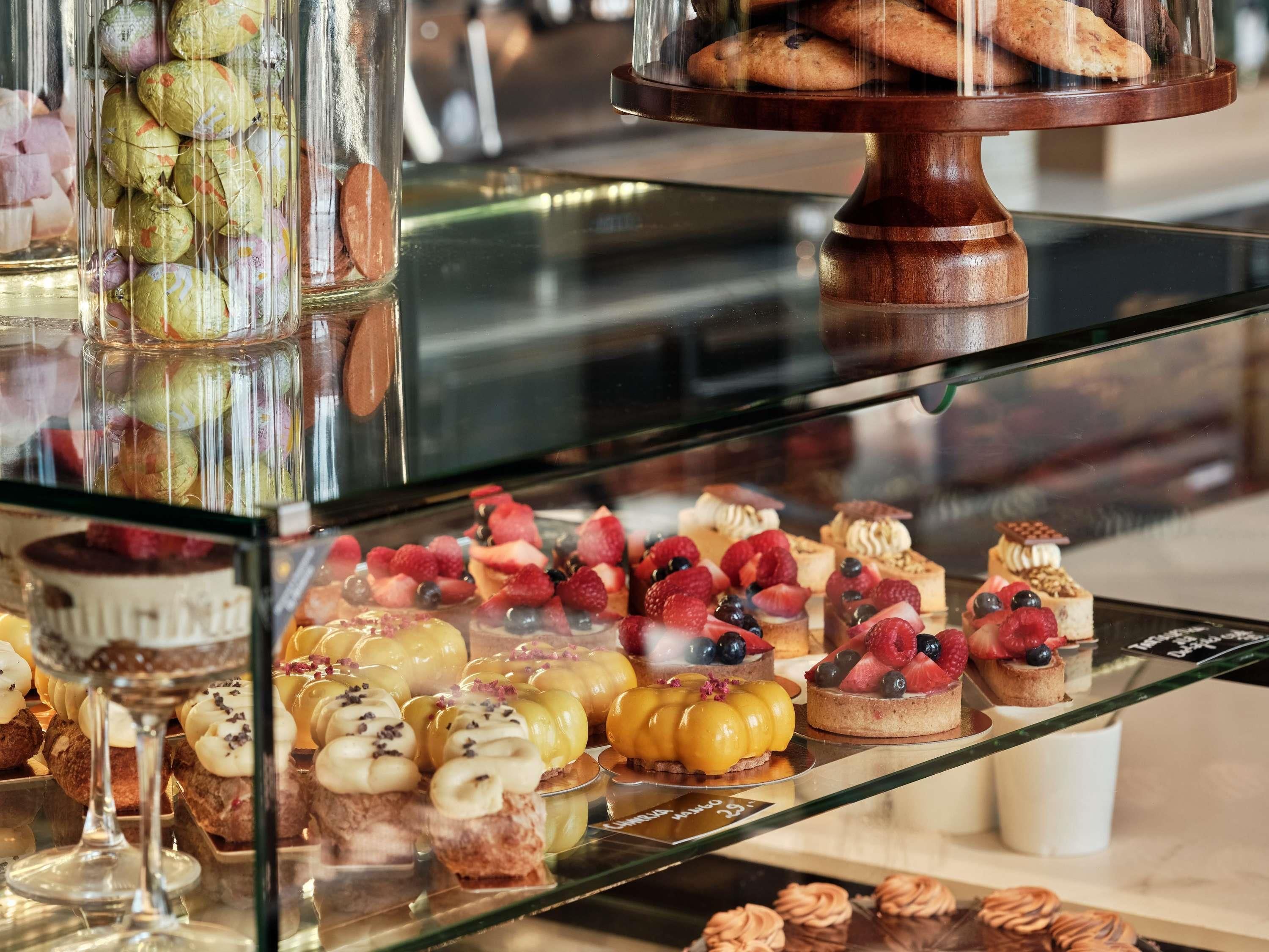A variety of desserts on display in a glass case.