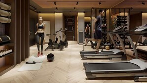 A modern gym with treadmills, exercise bikes, and a variety of fitness equipment. - Mövenpick Grand Hotel Wroclaw (Wroclaw)