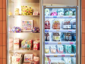 A refrigerated display case with various beverages and snacks. - Tribe Paris Clichy  (Clichy)